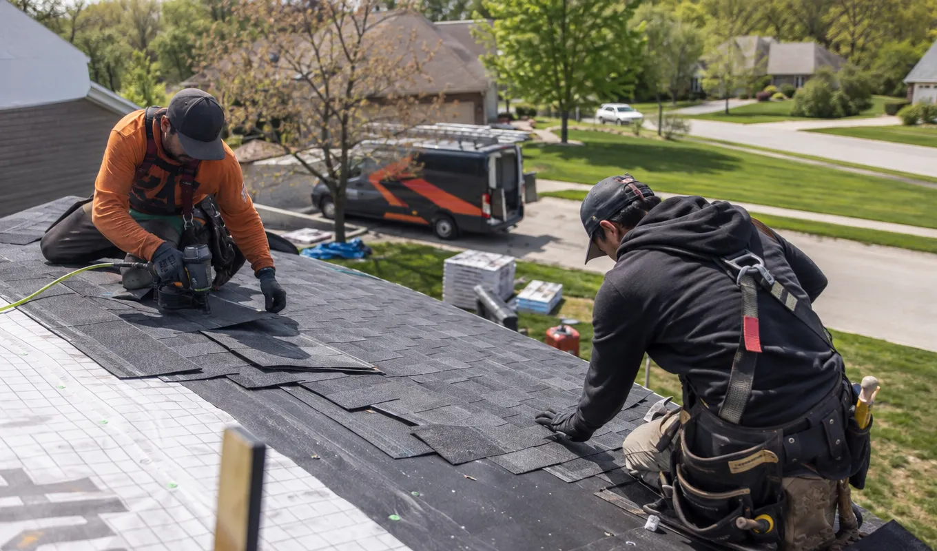 Roofing crew completing a job on a residential rooftop